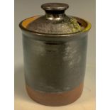 A Dame Lucie Rie style studio pottery preserve jar and cover, glazed in two tone metallic ark