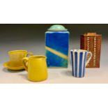A Sue Ford Bristol mustard teacup and saucer, seal mark; a similar jug; a mug, in vertical bands