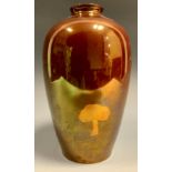 A Moorcroft Hazeldene lustre ovoid vase, tubelined with trees and rolling landscape on a red