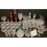 Glassware- a pair of cranberry overlay, etched, lidded vases; a crystal cut glass celery vase;