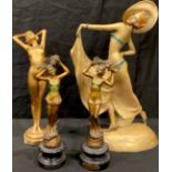 An Art Deco style painted chalk figure of a lady, holding her dress aloft, 50cm high, signed; a gold