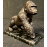 A bronzed metal sculpture of a gorilla, rectangular marble base, 18cm high