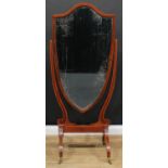 A Sheraton Revival mahogany cheval mirror, bevelled shield shaped plate, downswept legs, outlined