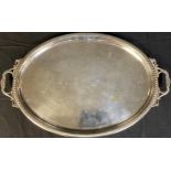 A large Victorian silver plated two handled oval tray, the centre engraved with floral swags,