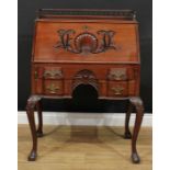 A George II Revival mahogany bureau, rectangular top with three-quarter gallery above a fall front