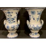 A pair of Meissen blue and white onion pattern two handled urn shaped vases, 25cm high