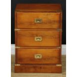 A contemporary campaign style brass-mounted yew veneer chest, of three drawers, carry handles to