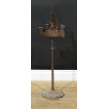 An Arts and Crafts wrought steel floor standing adjustable smoking companion, as a Viking