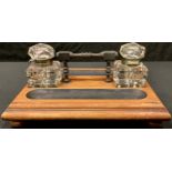 A Victorian mahogany desk stand, with a pair of glass inkwells