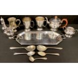 An EPNS three piece tea service, two handled tray; an EPNS sugar caster; EP mugs, spoons; qty