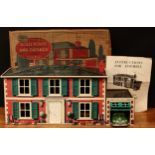 A Mettoy Playthings tinplate dolls house with 'self opening' garage, lithographed detail to the