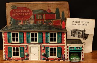 A Mettoy Playthings tinplate dolls house with 'self opening' garage, lithographed detail to the