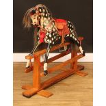 A J.Collinson and Sons rocking horse on safety stand, the carved, gesso and painted dappled horse