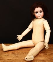 An Armand & Marseille (Germany) bisque head and partly fixed ball jointed composition bodied doll,