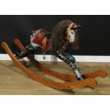 A 20th century rocking horse on a bow rocker, the carved and later over-painted/re-painted dappled