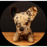 A 1930's Merrythought 'Booboo' type novelty seated dog, mottled black and cream, amber and black