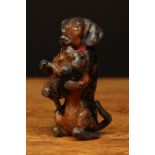 An early 20th century novelty cold painted lead figure in the form of a black and tan Dachshund