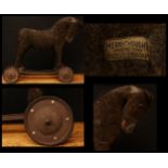 A 1930's Merrythought brown mohair Horse on wheels, straw filled body and head, large amber and