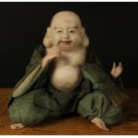 An early 20th century Chinese painted composition doll, of a Buddha, inset eyes, painted features,