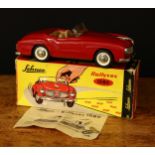 A Schuco (Germany) tinplate friction driven Rollyvox 1080 open top car, red body with beige/tan