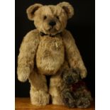 A large Charlie Bears teddy bear with ribbon collar and bells around neck, 76cm high; another