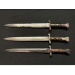 A collection of three Lee Metford bayonets: One maker marked "Sanderson 3/95" with double edged