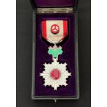Japanese Order of the Rising Sun (旭日章 Kyokujitsu-shō). Complete with ribbon and button hole device