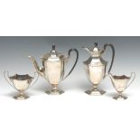 A George V silver four piece panelled urnular coffee service, comprising coffee pot, water jug, milk