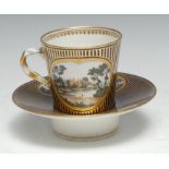 A Chelsea Derby French shape trembleuse cup and stand, painted with landscape within a gilt oval