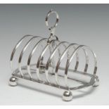 An Edwardian seven-bar toast rack, slightly arched, posted loop handle, ball feet, Walker and