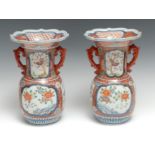 A pair of Japanese Imari baluster vases, painted with birds and flowers, wavy rim, 26cm high, signed