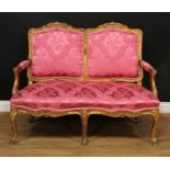 A 19th century giltwood and gesso sofa, stuffed-over upholstery, carved and applied throughout