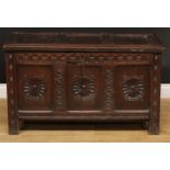 A 17th century oak blanket chest, hinged three panel top above a nulled frieze, the front three