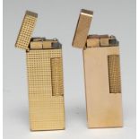 A Dunhill gold plated lighter, engine turned, 6.5cm long; another (2)