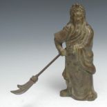 Chinese School. a brown patinated bronze, 20th century, of a elder holding a Kwan Dao, in flowing
