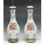 A large pair of famille verte armorial porcelain baluster table lamps, in the manner of 18th century