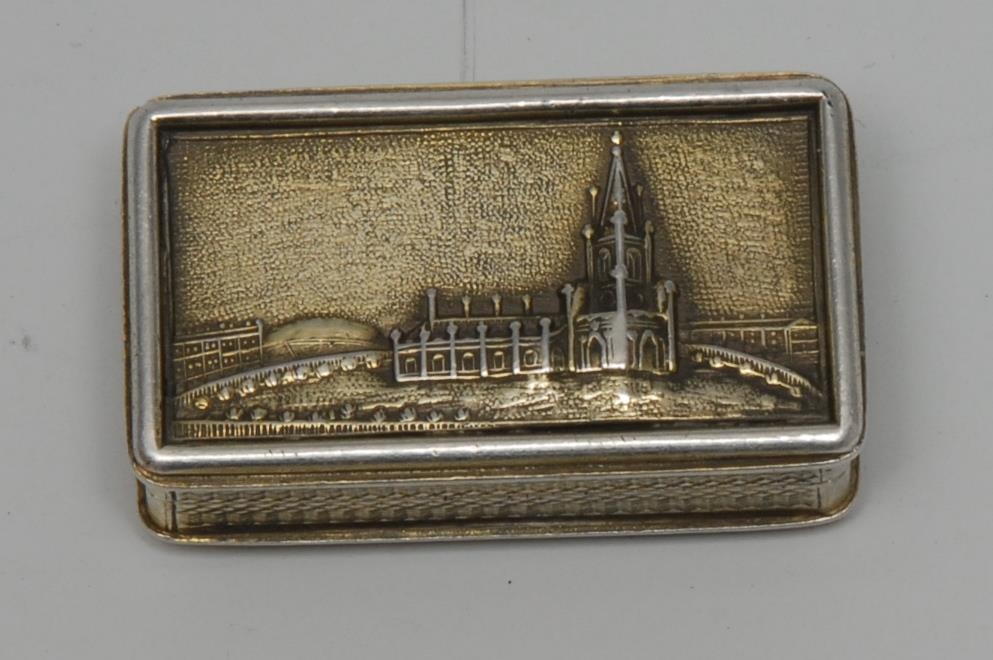 A rare George IV silver-gilt rounded rectangular castle top vinaigrette, the hinged cover embossed