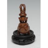A Chinese hardwood carving, of an acrobat upon the back of a three-legged toad, 9.5cm high, hardwood