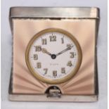 An Art Deco silver and guilloche enamel travelling boudoir timepiece, hinged cover engine turned