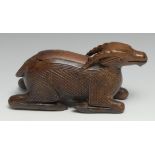 A 19th century treen novelty table snuff box, carved as a recumbent goat, sliding cover, 18cm long