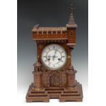 A late 19th century novelty oak mantel clock, as a romanticized castle, 13cm circular enamel dial