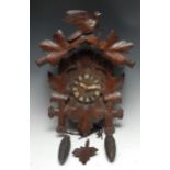 A Black Forest cuckoo clock, 11cm dial with Roman numerals, the movement striking on a gong, the