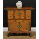 A Chinese brass-mounted elm side cabinet, of Japanese shodhana form, pagoda top above an arrangement