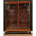 A 19th century mahogany library bookcase, moulded cornice above a deep frieze outlined with