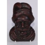 A North European oak boss, carved as the head of a moustached man, his hat with a feather, 14cm