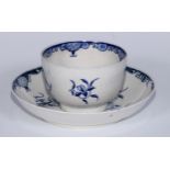 A Worcester Mansfield pattern tea bowl and saucer painted in blue with a large trailing flower, rare