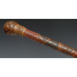 A Japanese bamboo walking stick, the cane shaft carved in alternating relief with geometric motifs