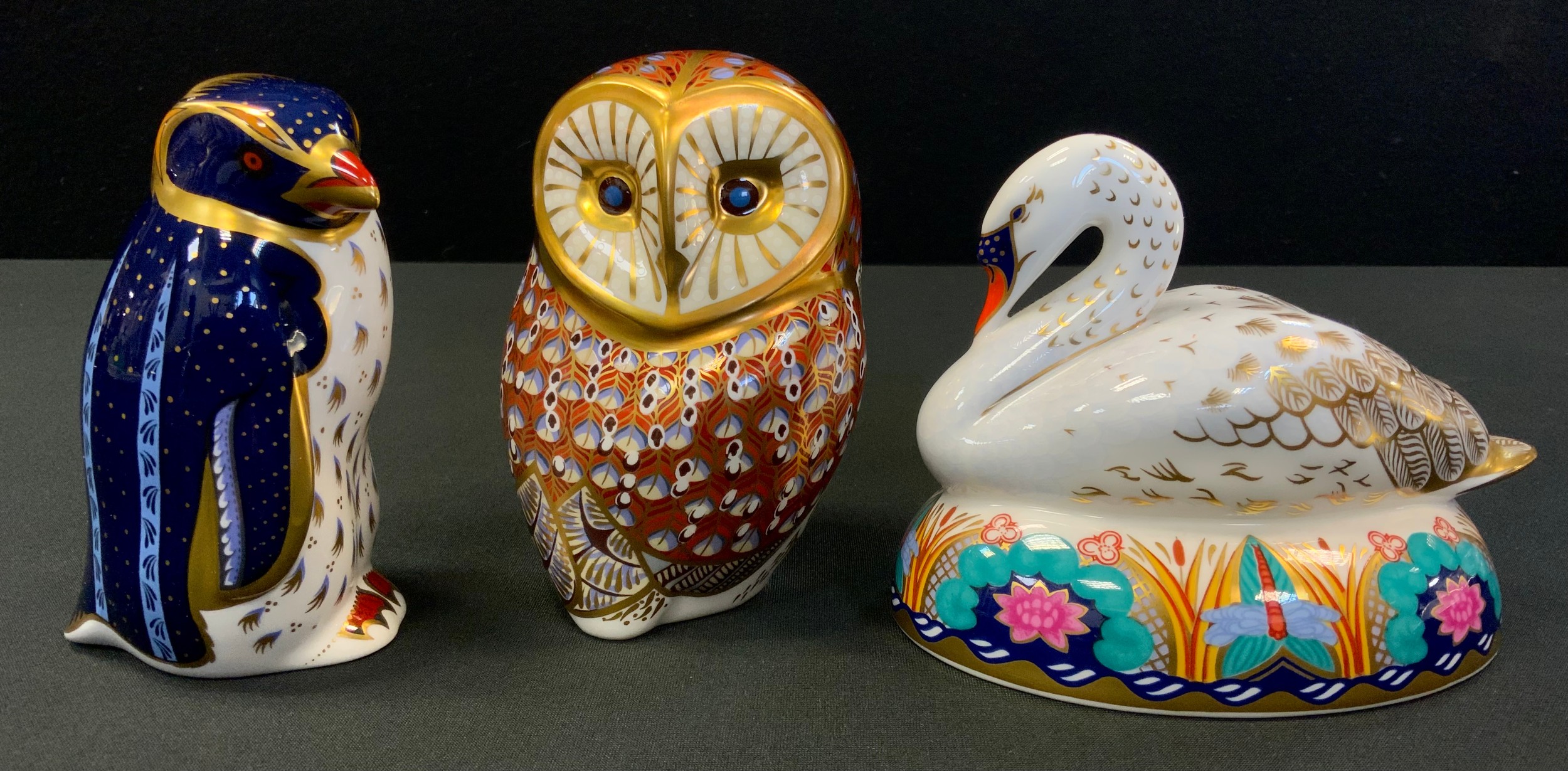 A Royal Crown Derby paperweight, Swan, gold stopper. printed mark; Owl; Rockhopper Penguin (3)