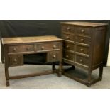 A Priory style chest of two short drawers with linen fold fronts over three plain panelled long