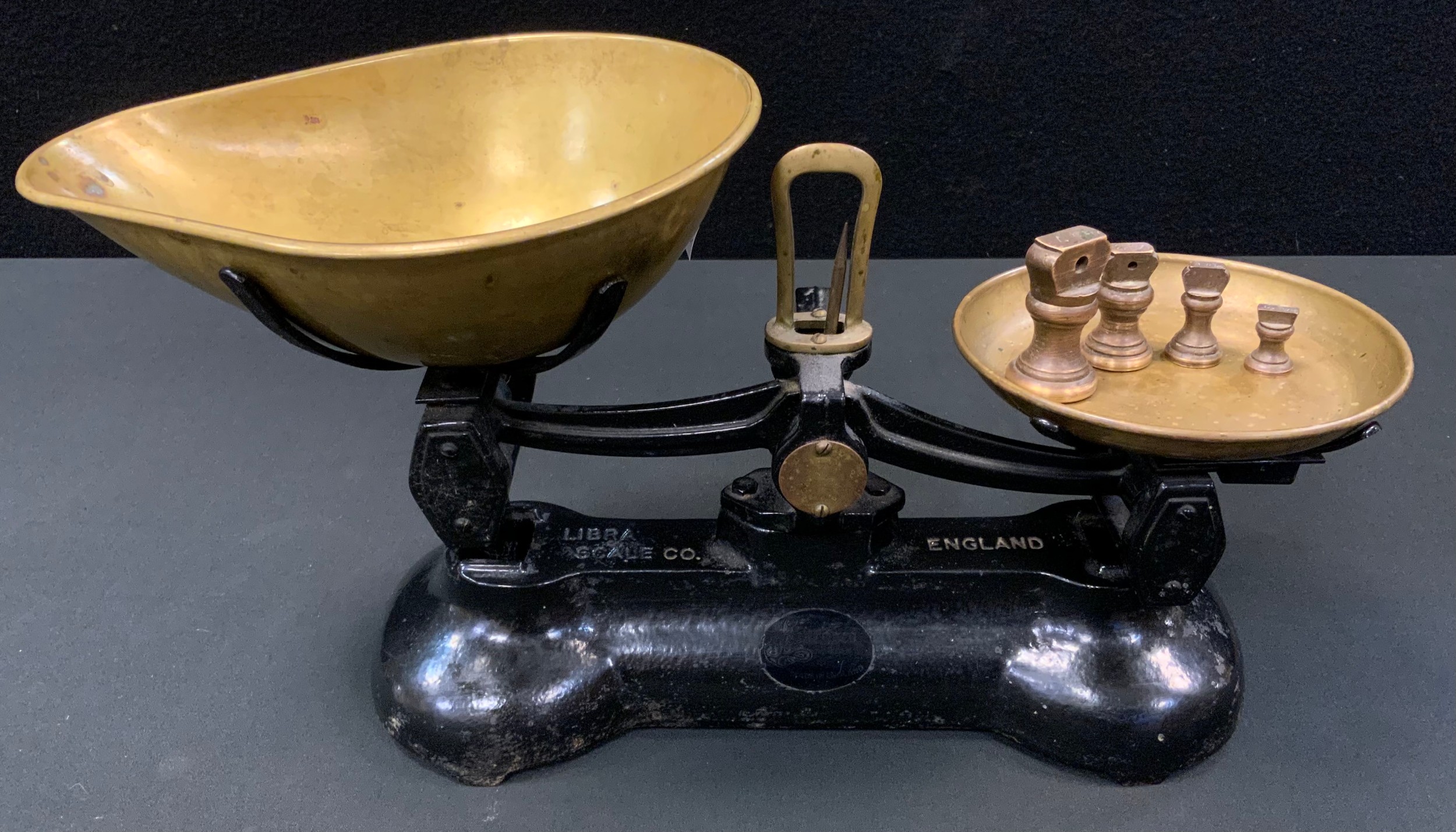 A set of Libra scale Co cast iron and brass scales, four bell weights